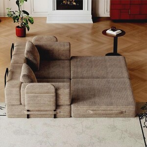 May include: A modular sofa bed upholstered in a light brown corduroy fabric. The piece features a low-profile design with integrated armrests, two back cushions, and a flat, extended base section that can be configured for seating or sleeping.
