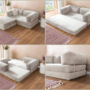 May include: A light gray modular sofa bed with a soft fabric finish and a metal frame. The piece features a convertible design that transitions from a standard sofa with an ottoman to a flat sleeping surface, showcasing its versatile configuration.