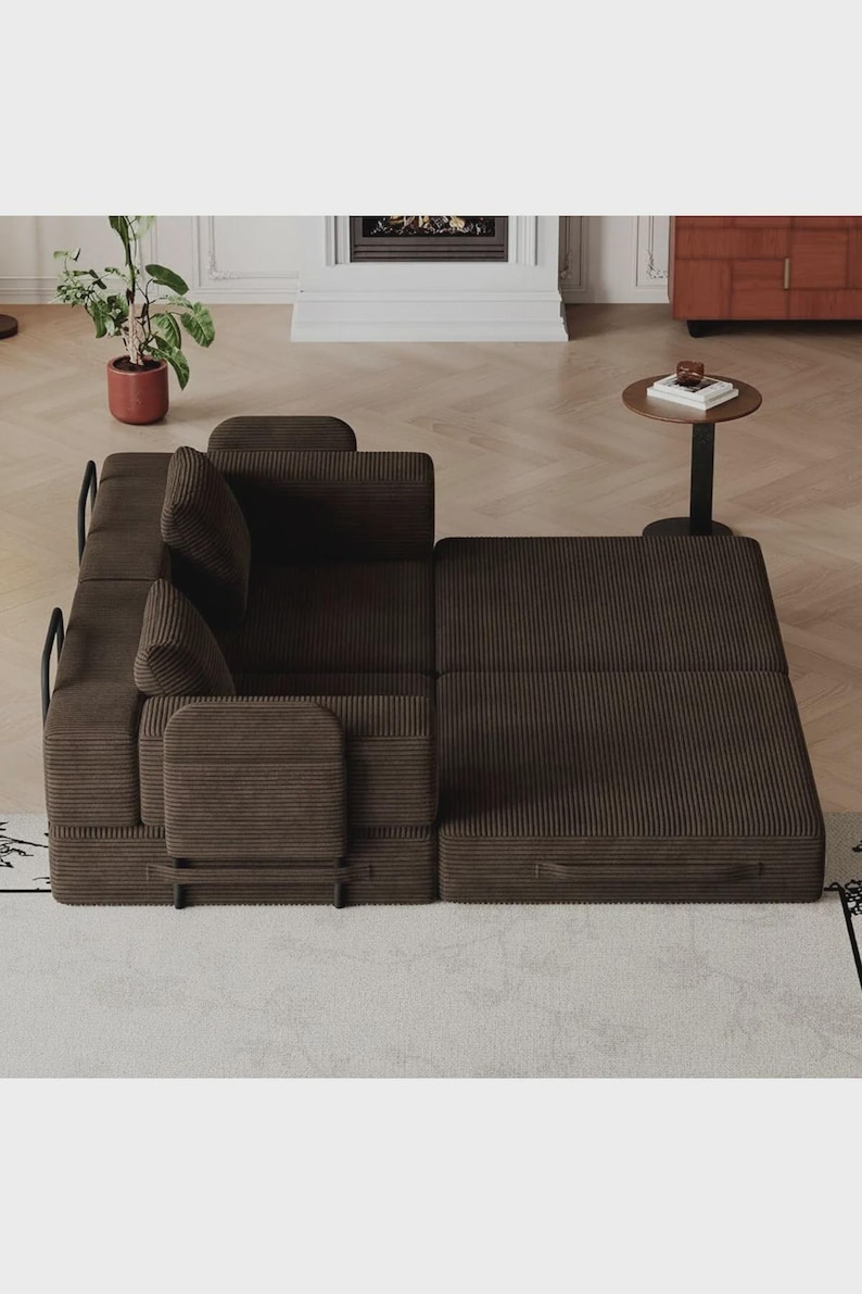 May include: A dark brown corduroy modular sofa bed featuring a textured fabric finish, black metal frame accents, and two back cushions. The piece is configured with one section in a seated position and the other extended flat as a bed.