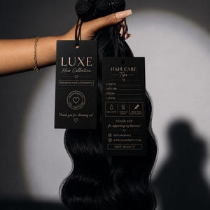 May include: A bundle of wavy black hair extensions with two black rectangular tags attached. The left tag reads LUXE Hair Collection Premium Hair Extensions. The right tag lists Hair Care Tips with icons for water, heat, and brushing, plus social media handles.