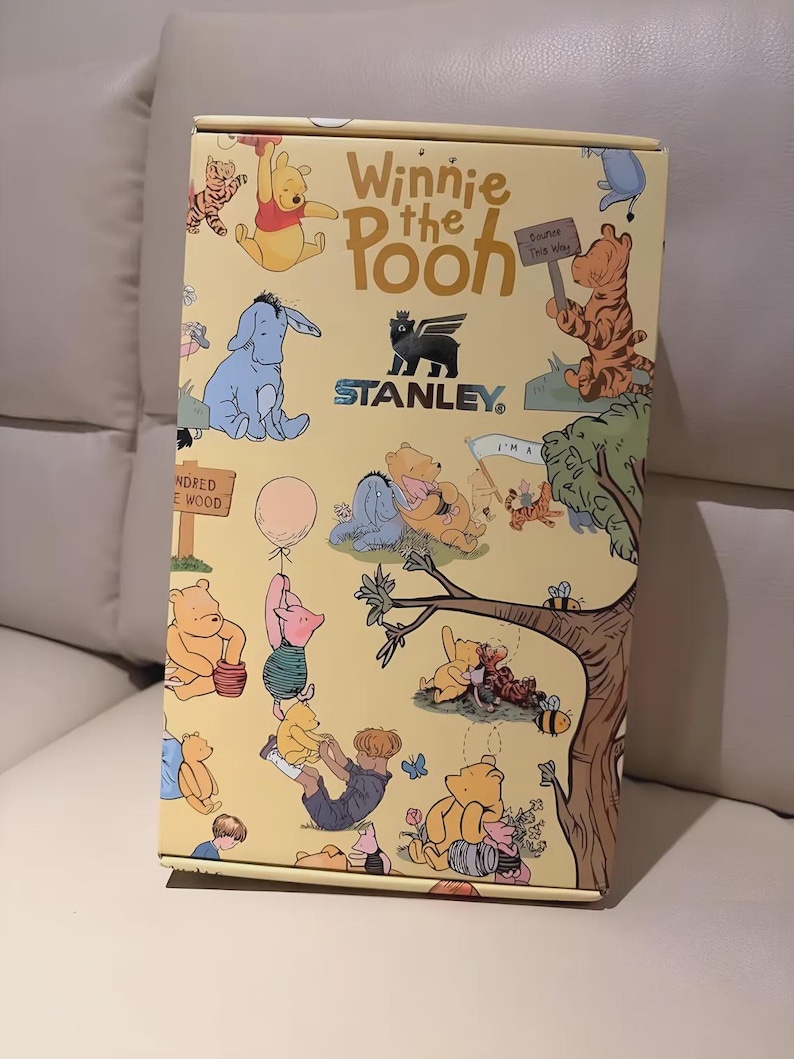 May include: A yellow box featuring illustrations of Winnie the Pooh characters. The box has the text "Winnie the Pooh" and the Stanley logo. The box is decorated with images of Pooh, Tigger, Eeyore, and Piglet.