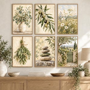 May include: A set of six framed wall art prints featuring botanical and landscape imagery. The prints display a vase with eucalyptus, an olive branch, a field of daisies, a bundle of herbs, a stack of stones, and a garden gate scene.