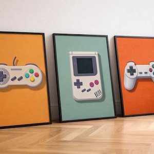 Peut inclure: Trois impressions encadrées présentant des manettes de jeu rétro et une console portable. Les impressions, dans des cadres noirs, sont sur des fonds orange, vert d'eau et corail. Les manettes sont blanches avec des boutons colorés.