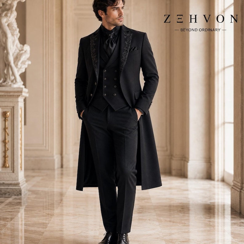 May include: A black three-piece suit featuring a long coat with embroidered lapels, a double-breasted vest, and matching trousers. The ensemble includes a black cravat and is branded with the text Z E H V O N BEYOND ORDINARY in the upper right corner.