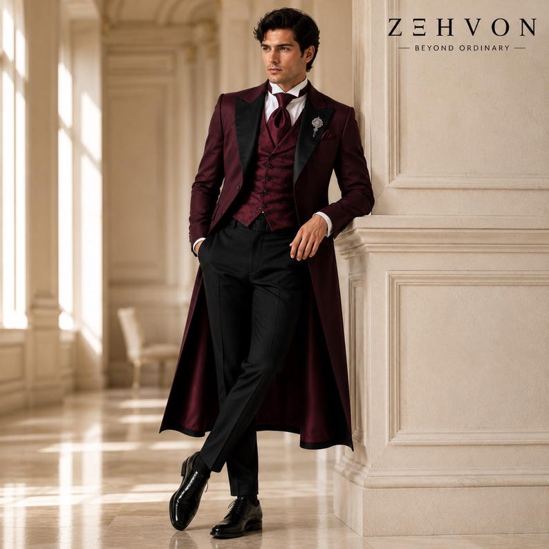 May include: A burgundy long-coat suit featuring a matching vest, a white collared shirt, a burgundy tie, and black trousers. The ensemble includes a silver lapel pin and black dress shoes. The text Z E H V O N BEYOND ORDINARY is visible.