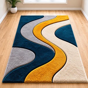 May include: A rectangular area rug featuring a high-pile texture with a wavy, multi-colored pattern. The design consists of flowing, curved sections in deep teal, mustard yellow, light gray, and cream, creating a layered, dimensional appearance.