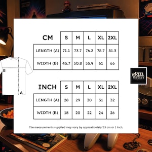 May include: A white t-shirt size chart featuring a line drawing of a t-shirt with length A and width B labels. Two tables display measurements in inches and centimeters for sizes S, M, L, XL, and 2XL. The text states measurements may vary by 1 inch.