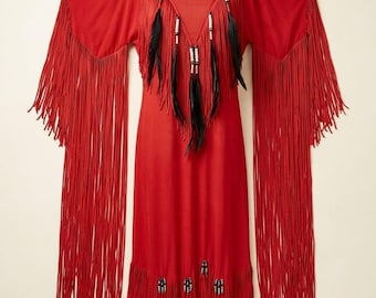 May include: A vibrant red dress with long fringe sleeves and a tiered fringe hem. The neckline features black feathers and white beads. This dress is a striking example of bohemian or Native American-inspired fashion.