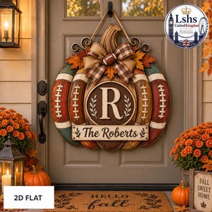May include: A pumpkin-shaped door sign featuring football-themed panels, a plaid bow with a small football accent, and a central circular plaque displaying the letter R. A rectangular nameplate below reads The Roberts in script lettering.