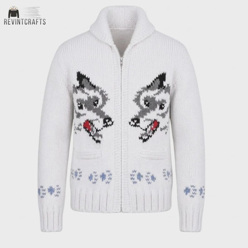 May include: A white zip-up knit cardigan featuring a shawl collar and long sleeves. The front displays two symmetrical wolf head motifs in gray, black, and red, with small blue paw print patterns near the ribbed hem and sleeve cuffs.