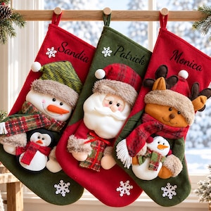 May include: Three Christmas stockings hanging from a wooden rod. The left is red with a snowman and penguin, labeled Sandia. The center is green with a Santa Claus, labeled Patrick. The right is red with a reindeer and snowman, labeled Monica.