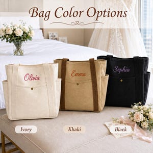 May include: Three canvas tote bags in ivory, khaki, and black, each featuring two side pockets, a front pocket with a snap button, and embroidered names. The text "Bag Color Options" appears at the top, with labels "Ivory," "Khaki," and "Black" below.