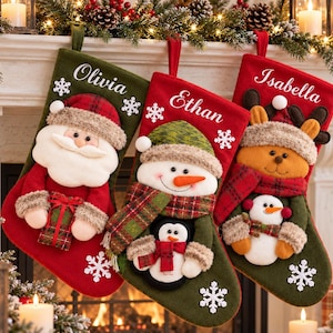 May include: Three Christmas stockings featuring plush characters: a Santa Claus on a green stocking, a snowman with a penguin on a red stocking, and a reindeer with a small snowman on a red stocking. Each stocking is personalized with names.
