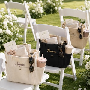 May include: Three canvas tote bags in cream and black, each personalized with embroidered names Alyssa, Brianna, and Katelyn. The bags feature multiple exterior pockets, containing a tumbler, sunglasses, a small pouch, and a thank you card.