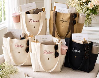May include: Five canvas tote bags in cream, tan, and black, each featuring a front pocket with a snap button, side pockets, and embroidered names: Brianna, Alyssa, Katelyn, Madison, and Sarah. Each bag contains a card reading Thank You.