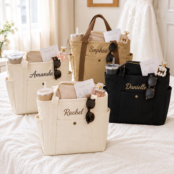 May include: Four canvas tote bags in cream, tan, and black, each featuring a front pocket with a snap button, side pockets, and a personalized name embroidered in script. Each bag contains a tumbler, a small pouch, a card, and sunglasses.