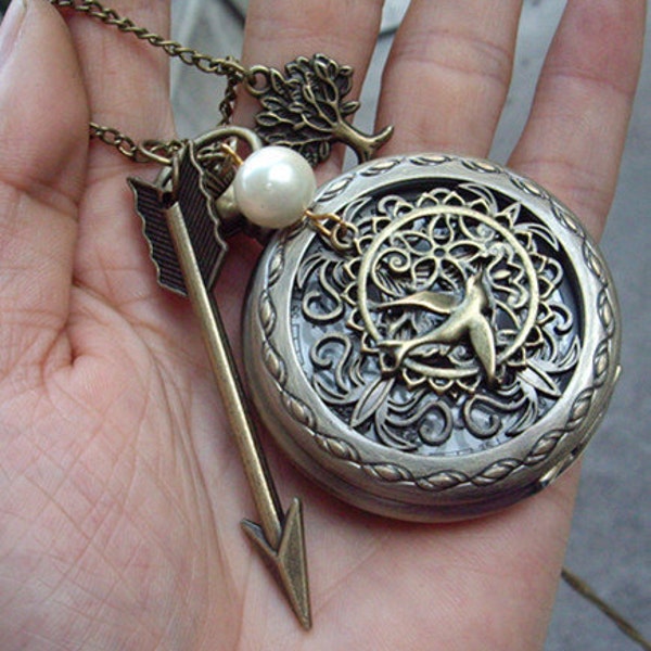 The Hunger Games Inspired Arrow with Mockingjay and Pearl heart skeleton  pocket watch locket necklace