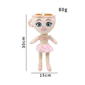 K&ouml;nnte beinhalten: Pl&uuml;schpuppe in Form einer Teetasse mit Gesicht, mit rosa Tutu und Ballettschuhen. Die Puppe ist 30 cm hoch und 15 cm breit und wiegt 80 g. Der Text "80g" ist sichtbar.