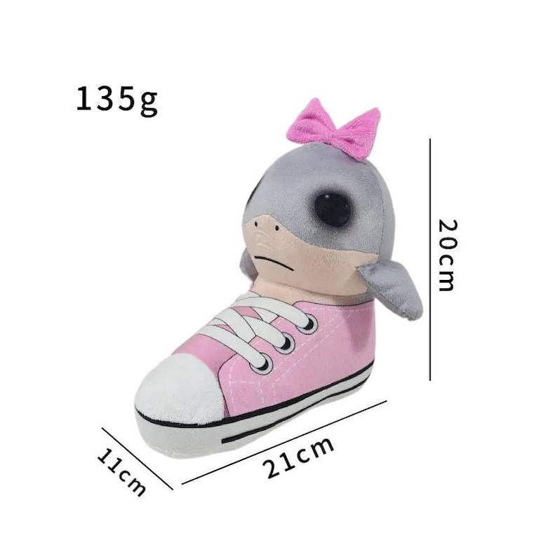 K&ouml;nnte beinhalten: Ein Pl&uuml;schtier mit einem grauen Robbenkopf mit einer rosa Schleife, der aus einem rosa Turnschuh herausragt. Der Turnschuh ist 21 cm lang, 11 cm breit und 20 cm hoch. Das Spielzeug wiegt 135g.
