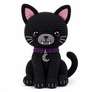 May include: A black crocheted cat plush toy with large black eyes, pink inner ears, a gray muzzle, and two white fangs. It wears a purple collar with a silver crescent moon charm. The cat has white stitched whiskers and paw details.