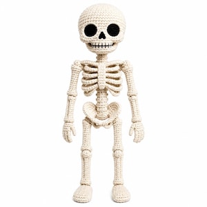 May include: A cream-colored crocheted skeleton doll featuring a round head with large black circular eye sockets, a small black triangular nose, and a stitched black mouth. The body displays a detailed rib cage, pelvic structure, and articulated limbs.