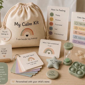 May include: A beige canvas bag labelled "My Calm Kit" with a rainbow graphic and the text "I can handle big feelings." The kit includes cards, a timer, a star-shaped plush, and a pop-it toy. The kit is designed to help children manage their feelings.