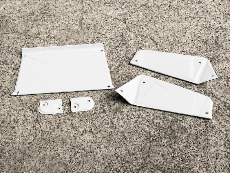 May include: A set of five white metal components including one large rectangular panel, two angled side panels, and two small mounting brackets, all featuring pre-drilled holes for assembly and a smooth, uniform white finish on all surfaces.