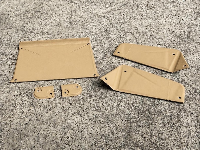 May include: A set of five tan-colored metal components featuring a flat rectangular piece, two elongated trapezoidal panels, and two small square-shaped brackets. Each piece includes pre-drilled circular holes for assembly and mounting purposes.