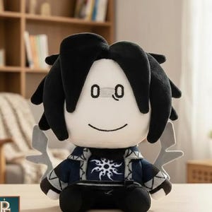 May include: A plush toy featuring a character with black hair, a white face, and embroidered eyes and mouth. The figure wears a dark blue jacket with a white sun-like emblem on the chest, grey wing-like accents, and black pants and shoes.