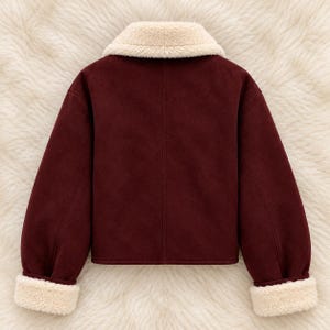 May include: A deep burgundy jacket featuring a soft cream-colored faux shearling collar and matching cuffs on the long sleeves. The jacket has a smooth, matte finish and a straight hemline, showcasing a clean, structured design.
