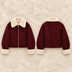 May include: A deep burgundy jacket featuring a cream-colored faux shearling collar and matching cuffs. The front displays a full-length silver zipper closure and two side pockets, while the back shows a clean, solid panel design.