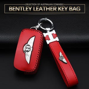 May include: Red leather key bag featuring a silver Bentley logo. The key bag has a matching red leather strap with a silver accent. The text "BENTLEY LEATHER KEY BAG" is at the top of the image.