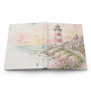 May include: A journal with a watercolor illustration of a lighthouse on a rocky coast. The lighthouse is red and white, with a small house nearby. The ocean and sky are painted in soft pastel colors, with sailboats in the distance.