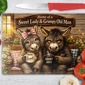 May include: A rectangular glass cutting board featuring an illustration of two donkeys sitting on a bench. The left donkey wears a pink bow and holds a mug labeled Sweet, while the right donkey holds a mug labeled Grumpy Juice. Text reads Home of a Sweet Lady & Grumpy Old Man.