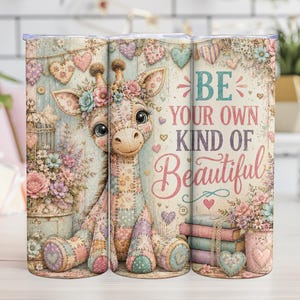 May include: A cylindrical tumbler featuring a patchwork-style giraffe illustration with floral accents, surrounded by hearts and books. The text reads BE YOUR OWN KIND OF Beautiful in a mix of block and script fonts against a soft, vintage-inspired background.