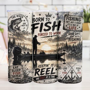 May include: A stainless steel tumbler with a fishing theme. The design features a fisherman on a boat, a lake scene, and text that reads "Born to Fish, Forced to Work." Additional text includes "The River is Calling" and "Eat Sleep Fish Repeat."