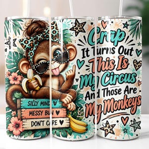 May include: A cylindrical tumbler featuring a cartoon monkey wearing sunglasses and a leopard print bow, holding a banana. The design includes tropical leaves, flowers, and text that reads: Crap It Turns Out This Is My Circus And Those Are My Monkeys.