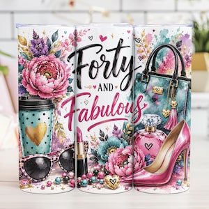 May include: A cylindrical tumbler featuring a colorful watercolor design with the text Forty and Fabulous. The print includes a handbag, a high-heeled shoe, a perfume bottle, a lipstick, sunglasses, a coffee cup, and floral arrangements in pink and teal.