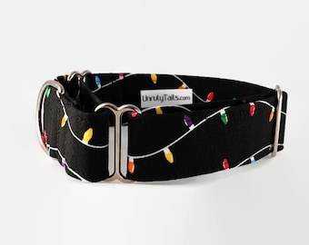 May include: Black martingale dog collar with a white string of colorful Christmas lights pattern. The collar has silver hardware and the text "UnrulyTails.com" is printed on the collar.