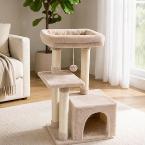 May include: A beige cat tree featuring a square top perch with raised edges, a middle platform, and a lower enclosed cubby house. The structure includes three vertical posts wrapped in sisal rope and a small hanging ball toy suspended from the top.