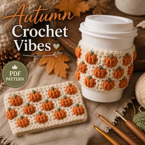 May include: A white coffee cup with a cream-colored crochet sleeve featuring orange pumpkin motifs, accompanied by a matching rectangular crochet piece, three wooden crochet hooks, and text reading Autumn Crochet Vibes PDF PATTERN.