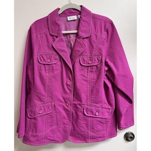 May include: A magenta colored, long-sleeved, button-up jacket with multiple pockets. The jacket has a d.c.co. label on the front.