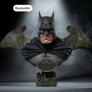 May include: A detailed bust of Batman, featuring a black cowl and cape. The bust includes the iconic bat symbol on the chest and is set against a smoky background. The base has a detailed architectural design.
