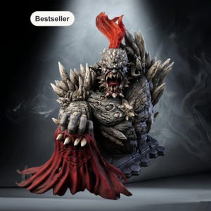 May include: A detailed statue of a monstrous figure with sharp teeth, spikes, and a red, flame-like crest. The figure is holding a red cape with the Superman logo. The statue is on a dark base and has a "Bestseller" label.