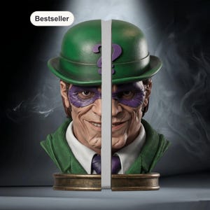 May include: The Riddler bust bookends. The bust features a green bowler hat with a purple question mark, a purple mask, and a green suit. The bookends are made of a bronze-colored material and are split down the middle.