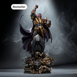 May include: A Batman statue in a dynamic pose, featuring a gold and black armored suit with a purple cape. The statue is set on a detailed base with skulls and gargoyles. The word "Bestseller" is in a white oval.