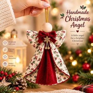May include: A fabric Christmas angel ornament featuring a cream-colored dress with a green holly and red berry print, accented by a deep red velvet center panel, a matching velvet bow, a gold snowflake charm, and a smooth wooden bead head.