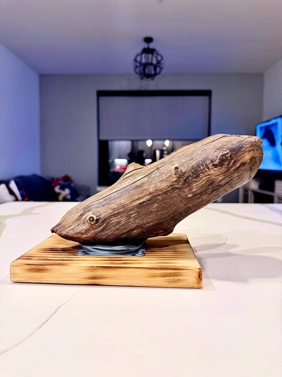 Reclaimed driftwood meets spinning metal in a one-of-a-kind industrial kinetic piece that is literally unrepeatable — no two are the same.