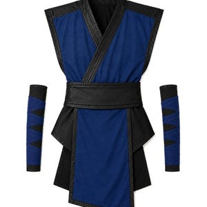 May include: A sleeveless blue and black tunic featuring a wrap-style front, a wide black waistband, and a long rectangular panel. The set includes two matching blue and black arm guards with a crisscross pattern, all constructed with dark trim.