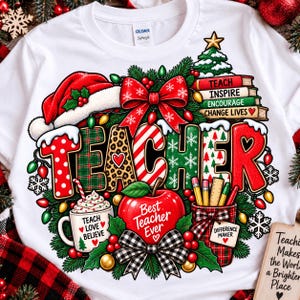 May include: A white t-shirt featuring a festive graphic with the word TEACHER in colourful patterns. The design includes a Santa hat, a stack of books labelled TEACH INSPIRE ENCOURAGE CHANGE LIVES, a mug saying TEACH LOVE BELIEVE, and an apple.
